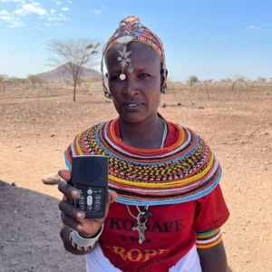 A Samburu Woman in Kenya holding a MegaVoice device